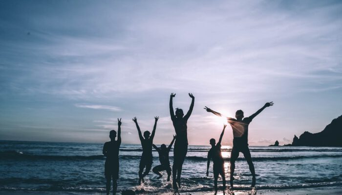 mensen springen op het strand